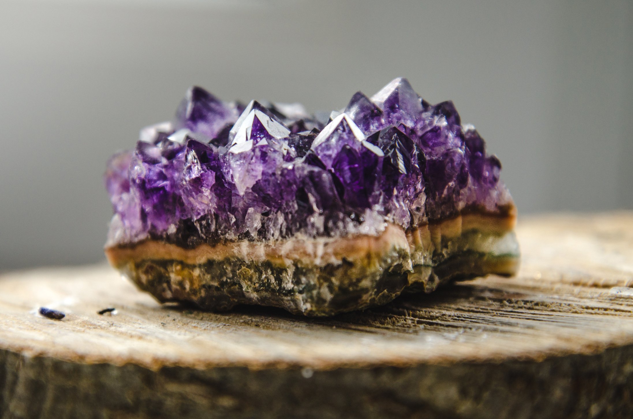 Raw amethyst rock with reflection on natural wood crystal  ametist